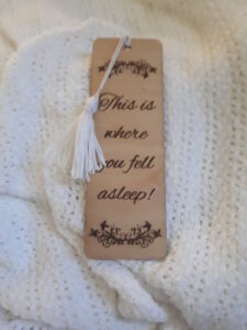 Wooden bookmark with white tassel, laser engraved with the text 'This is where you fell asleep!'