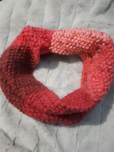 Seed stitch cowl done in a pink ombre acrylic yarn