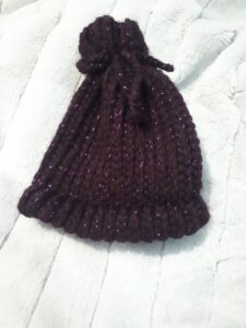 Baby hat loom knit in dark purple sparkly yarn