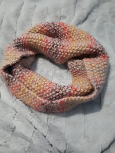 Seed stitch cowl in self striping acrylic yarn